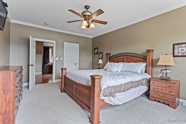 bedroom with light colored carpet, ceiling fan, baseboards, and ornamental molding