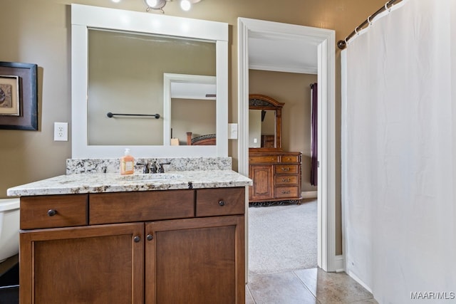 ensuite bathroom featuring tile patterned flooring, ensuite bath, vanity, and crown molding