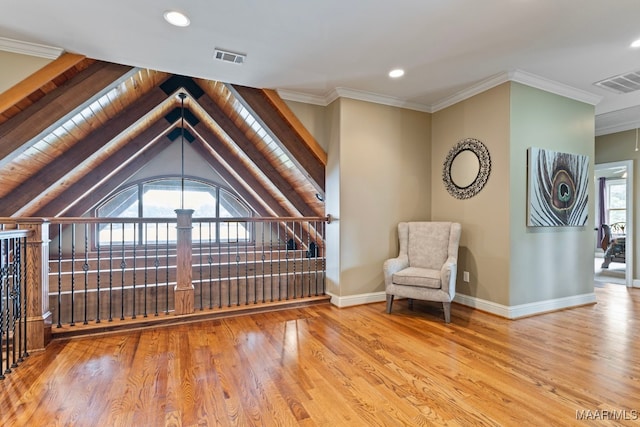 unfurnished room with visible vents, baseboards, wood finished floors, and ornamental molding