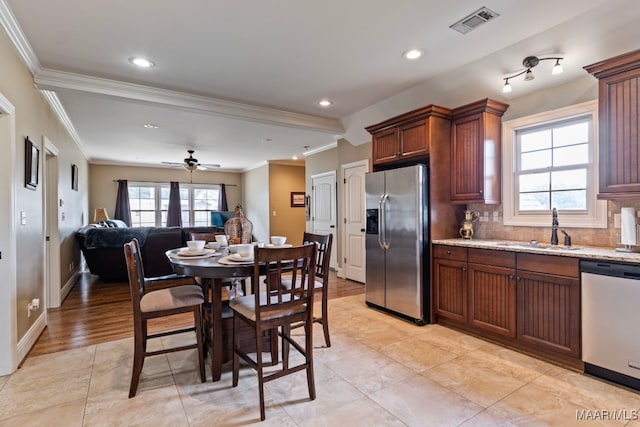 kitchen with plenty of natural light, visible vents, appliances with stainless steel finishes, open floor plan, and light stone countertops