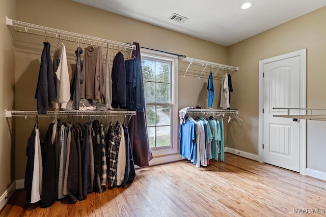 spacious closet with wood finished floors and visible vents