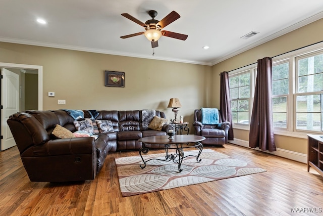 living room featuring visible vents, a ceiling fan, wood finished floors, crown molding, and baseboards