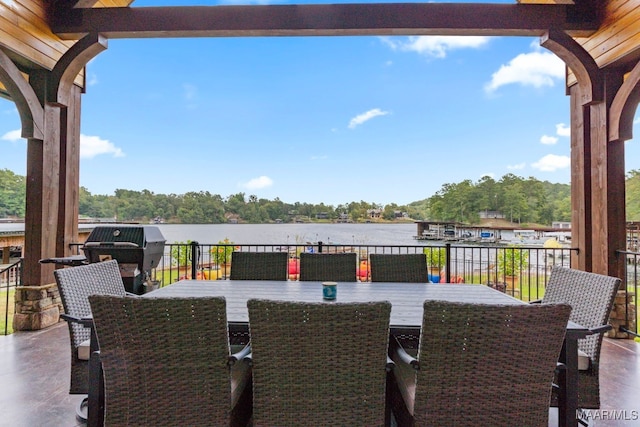 view of patio / terrace with area for grilling, outdoor dining area, and a water view