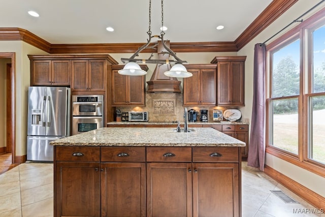 kitchen featuring a kitchen island with sink, stainless steel appliances, visible vents, custom range hood, and pendant lighting