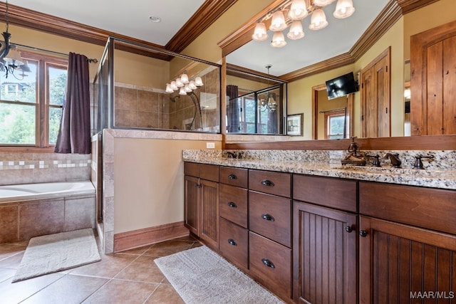 bathroom with an inviting chandelier, double vanity, a tile shower, ornamental molding, and tile patterned flooring