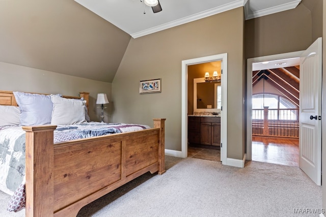 bedroom with crown molding, light carpet, connected bathroom, vaulted ceiling, and baseboards