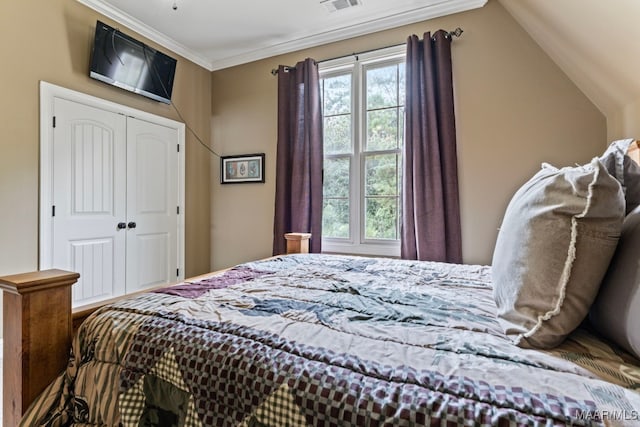 bedroom with ornamental molding, multiple windows, a closet, and visible vents