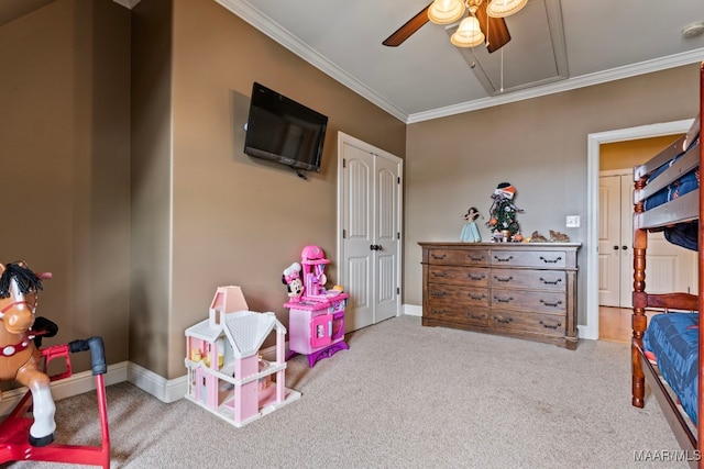 carpeted bedroom featuring baseboards, a closet, attic access, and crown molding