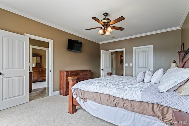 bedroom featuring a ceiling fan, baseboards, carpet floors, ensuite bathroom, and crown molding