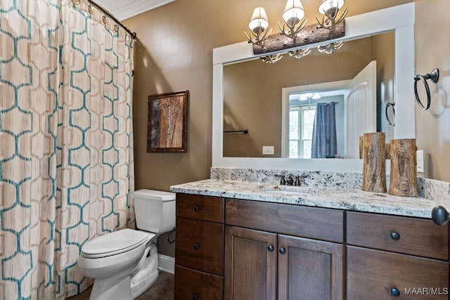 bathroom with curtained shower, toilet, vanity, and crown molding