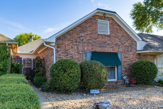 view of property exterior with brick siding