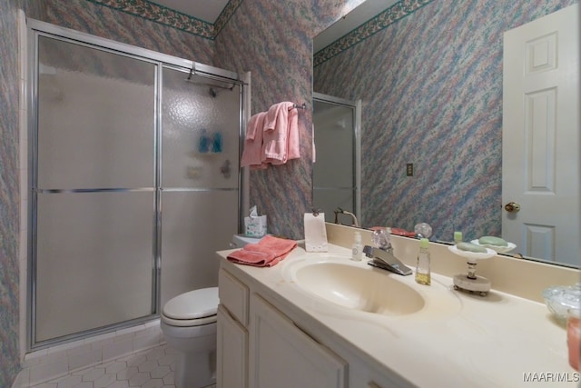 bathroom featuring vanity, toilet, an enclosed shower, and tile patterned floors