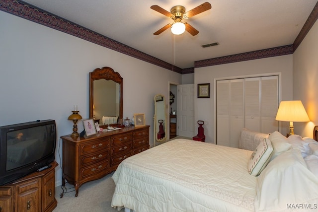 bedroom with light carpet, ceiling fan, a closet, and visible vents