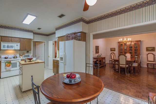 dining area featuring light floors, visible vents, wallpapered walls, baseboards, and ceiling fan with notable chandelier