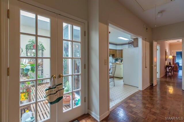 entryway featuring dark parquet flooring and french doors