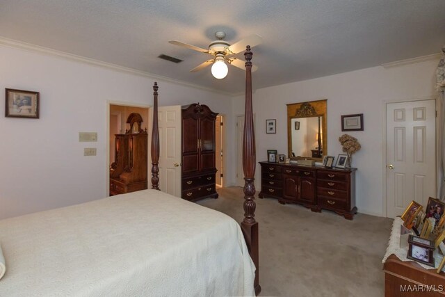 bedroom with a textured ceiling, crown molding, ceiling fan, and light carpet