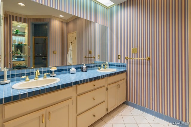 bathroom featuring vanity, tasteful backsplash, and tile patterned flooring