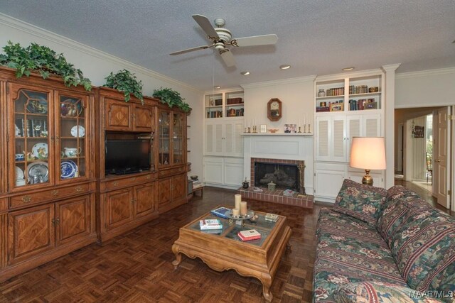 living room featuring dark parquet flooring, ceiling fan, a fireplace, and a textured ceiling