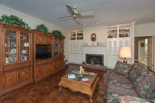 living area with built in features, a fireplace, ornamental molding, and a textured ceiling