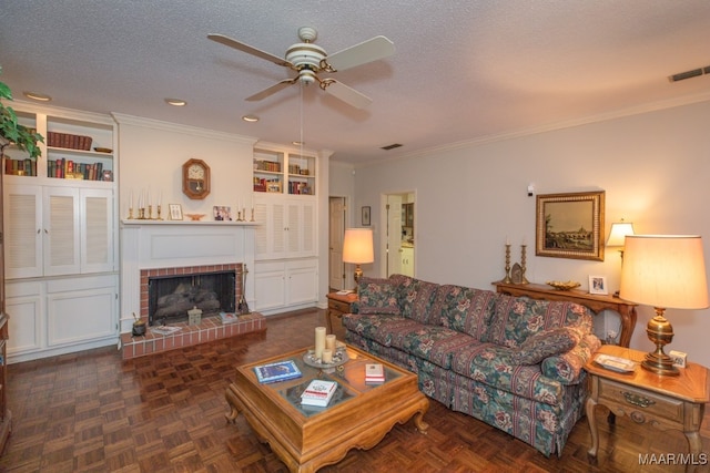 living area with ornamental molding, a brick fireplace, visible vents, and a textured ceiling