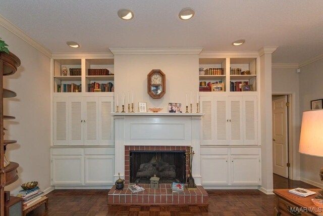 living room with dark parquet floors, ornamental molding, a textured ceiling, and a brick fireplace