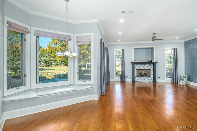 unfurnished living room with ceiling fan, ornamental molding, and hardwood / wood-style flooring