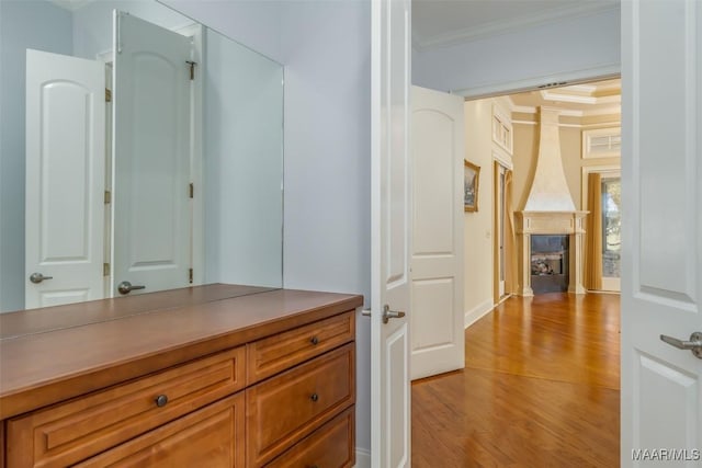 bathroom with wood-type flooring and crown molding