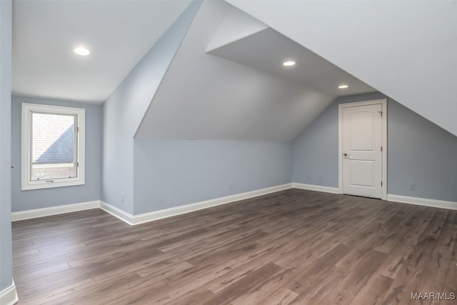 additional living space with lofted ceiling and dark hardwood / wood-style floors