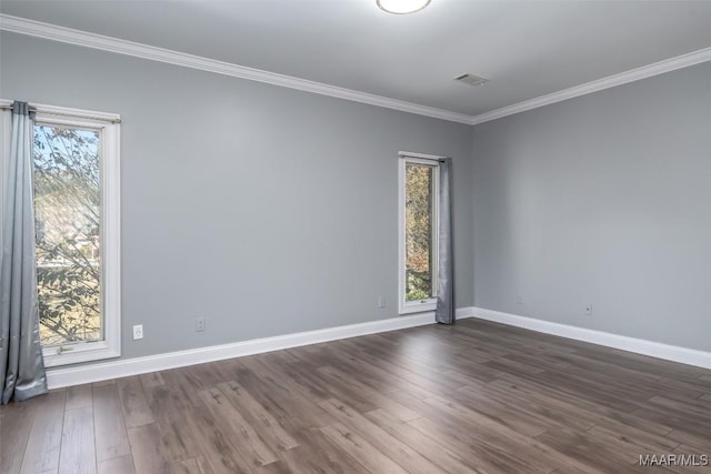 spare room featuring dark hardwood / wood-style flooring and ornamental molding