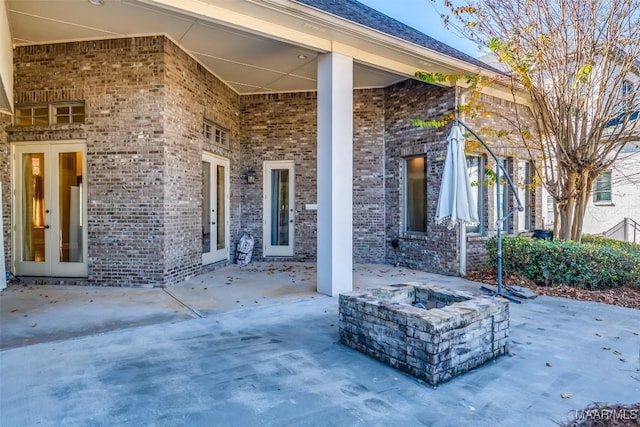 view of patio with french doors and an outdoor fire pit