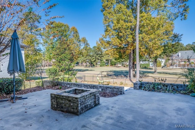 view of patio with a fire pit