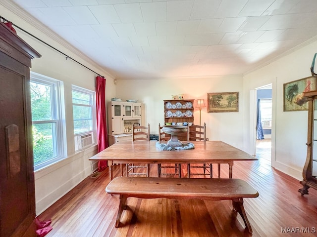 dining room featuring crown molding and hardwood / wood-style floors