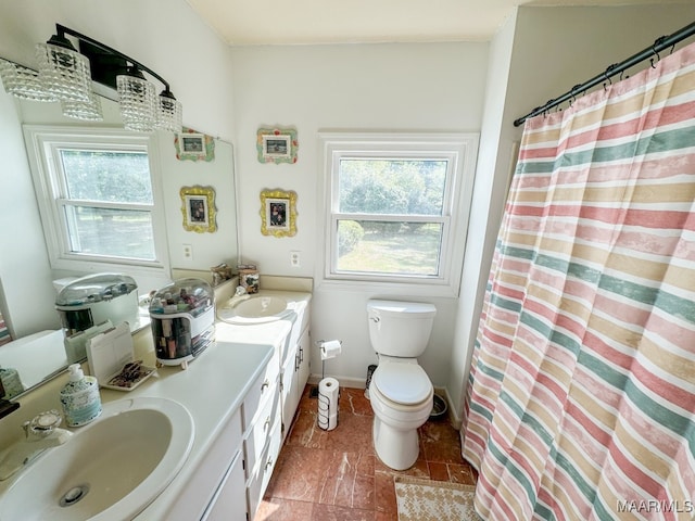 bathroom with vanity, toilet, and curtained shower