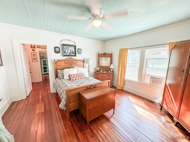 bedroom featuring hardwood / wood-style floors, ornamental molding, cooling unit, ceiling fan, and wooden ceiling