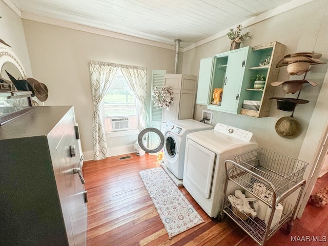 laundry room featuring ornamental molding, wood ceiling, washing machine and dryer, and dark hardwood / wood-style floors