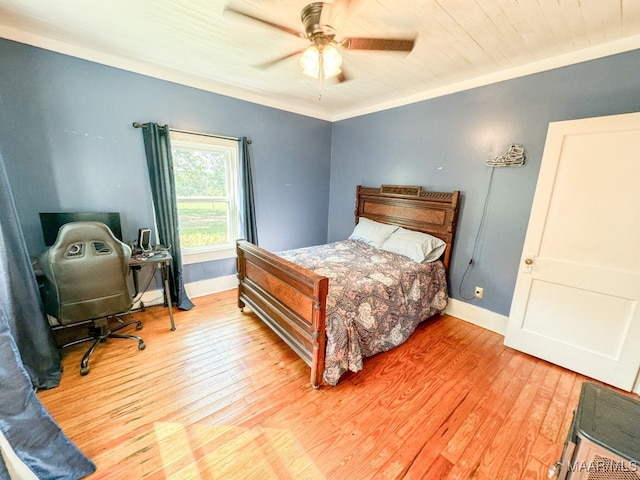 bedroom featuring light wood-type flooring, ceiling fan, and ornamental molding