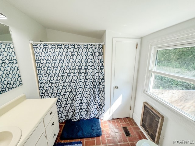 bathroom with vanity and vaulted ceiling