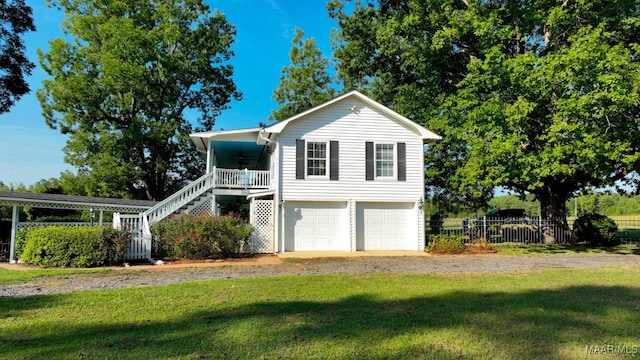 view of front of house with a garage, a front yard, and a porch