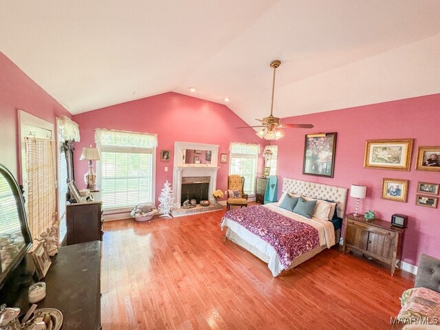 bedroom with lofted ceiling, wood-type flooring, and ceiling fan