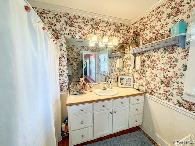 bathroom featuring hardwood / wood-style flooring, ornamental molding, and vanity