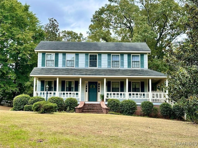 colonial house featuring covered porch and a front lawn