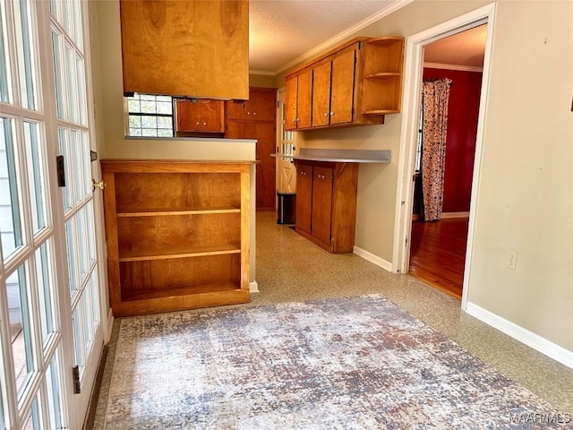 kitchen featuring brown cabinetry, baseboards, open shelves, and crown molding