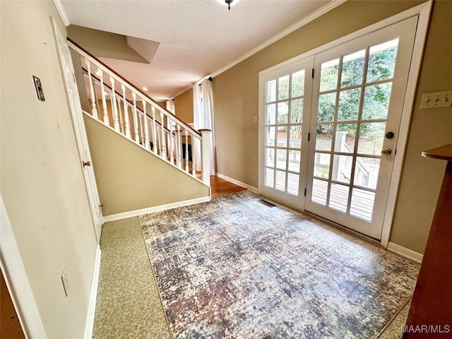 doorway with visible vents, stairs, baseboards, and crown molding