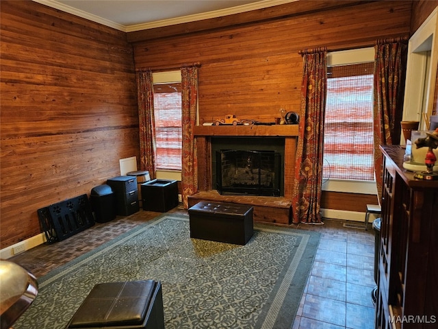 living room with dark tile patterned flooring, wood walls, and crown molding