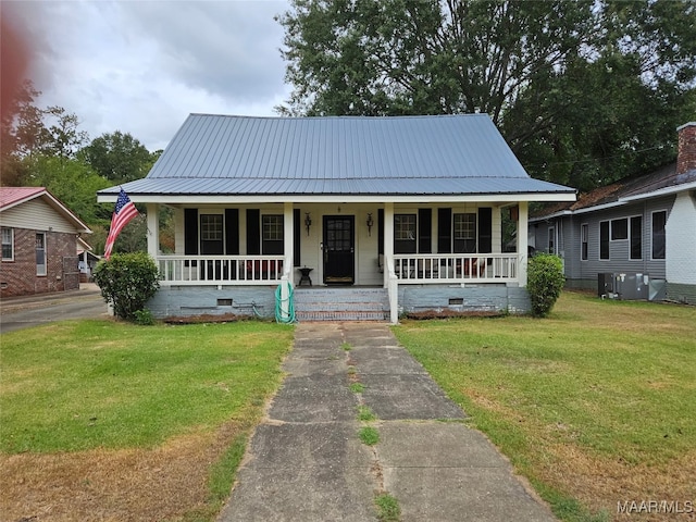 view of front of home with a porch, central AC, and a front yard