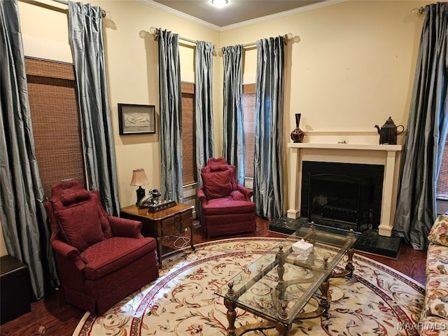 sitting room with hardwood / wood-style flooring and ornamental molding