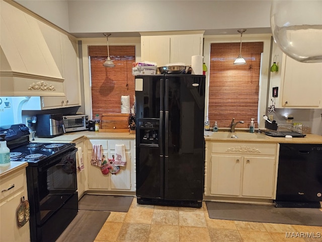 kitchen with black appliances, pendant lighting, premium range hood, and sink