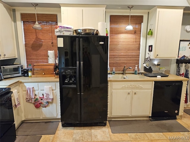 kitchen featuring black appliances, sink, and hanging light fixtures