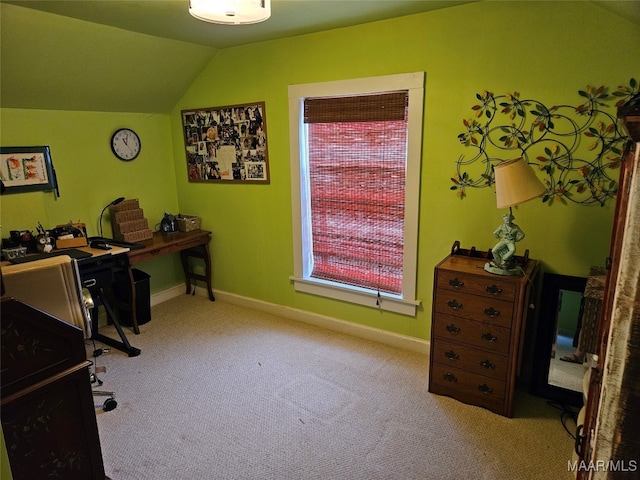 home office with lofted ceiling and carpet