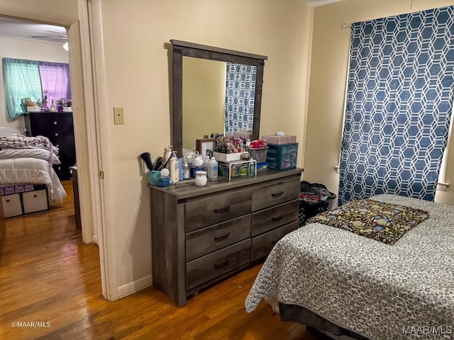 bedroom with hardwood / wood-style flooring